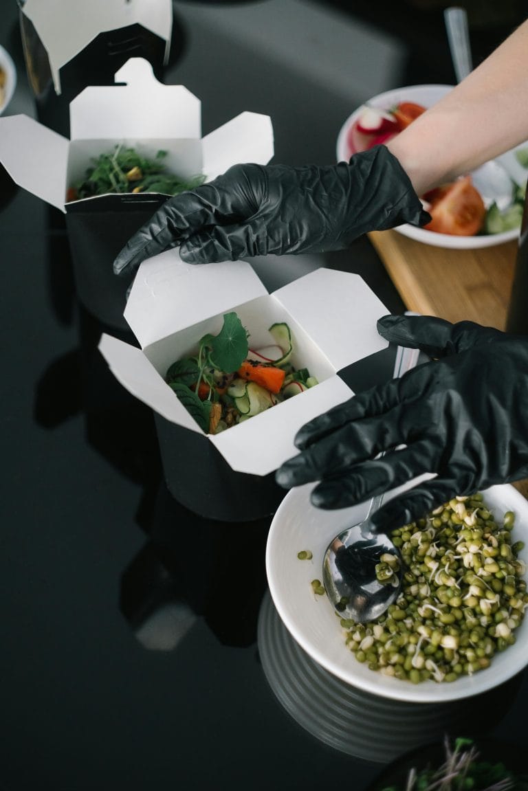 Restaurant staff preparing online catering orders for delivery and pickup